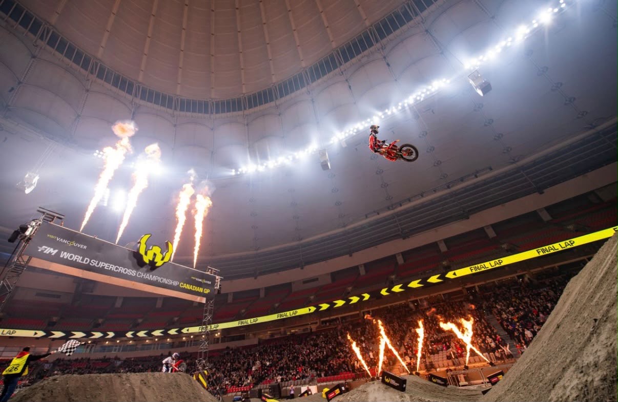 Rider above a stadium supercross track under lights